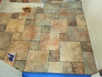 20151108 164626  Nov 8 2015 - Finally getting around to installing floor tile in the bathroom.  I'm using tile that was leftover from when I redid the pool bathroom in the house. Because I wanted to anchor the tile pattern in front of the bathroom door and I don't have the confidence in my tile measuring/cutting/laying to start in the back corner I chose to start in front of the door and work my my towards the back corner. This required three tile laying sessions but that's ok because I wasn't in any hurry.